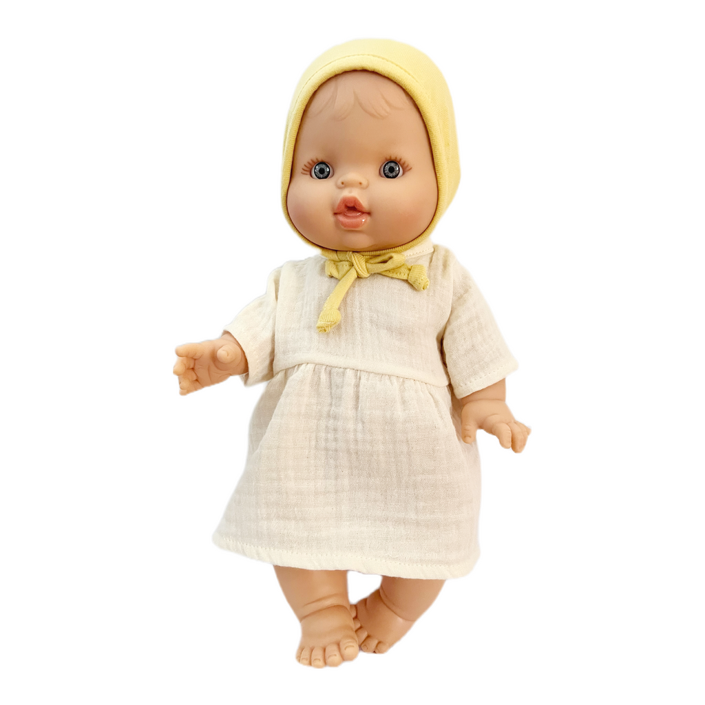 Minikane Bath Baby Girl Doll in Cream Gauze Dress and Lemon Bonnet · White